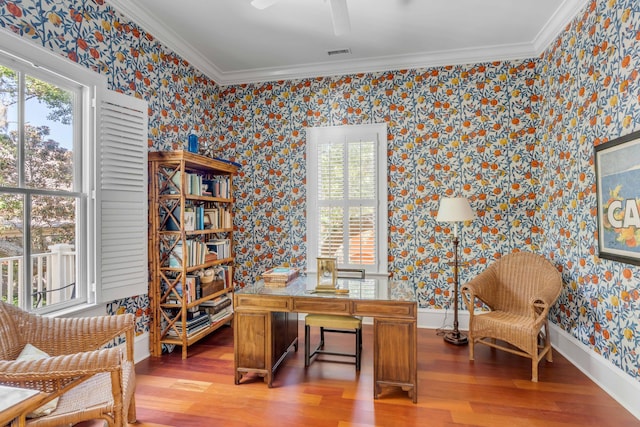 office with baseboards, wallpapered walls, wood finished floors, and crown molding