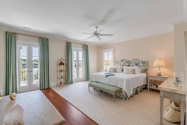 bedroom with french doors, multiple windows, and access to outside