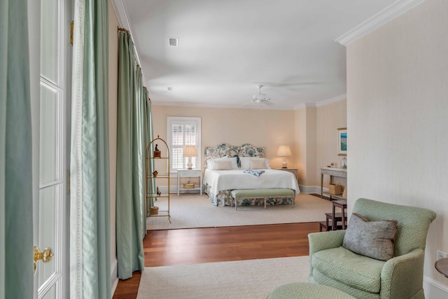 bedroom featuring ceiling fan, hardwood / wood-style flooring, and ornamental molding