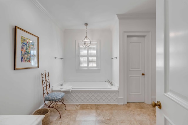 bathroom with a chandelier, ornamental molding, and a bath
