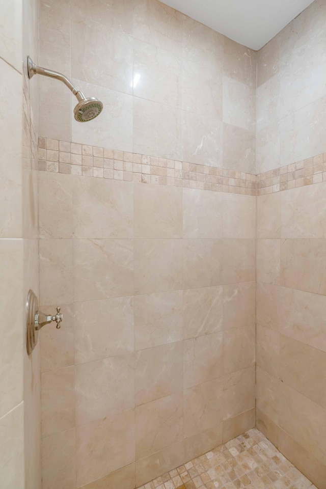 bathroom with a tile shower