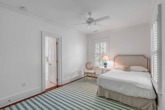 bedroom with connected bathroom, ceiling fan, and crown molding