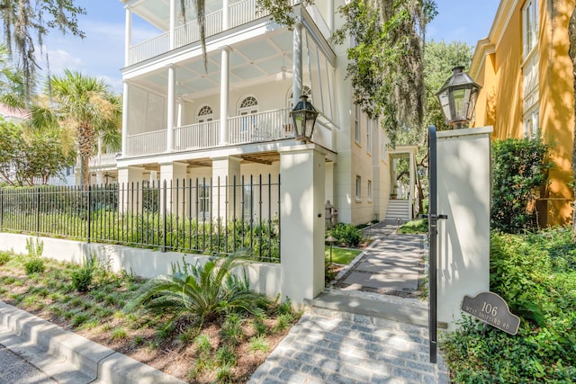exterior space with fence, stucco siding, and a balcony