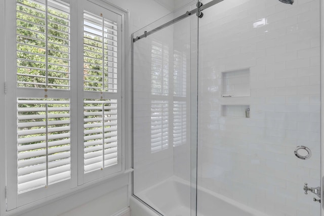 bathroom with shower / bath combination with glass door