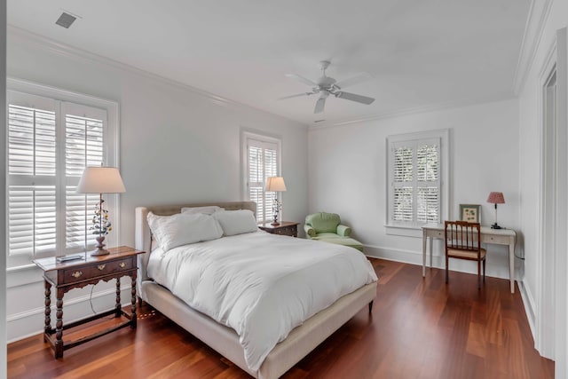 bedroom featuring ceiling fan, crown molding, dark hardwood / wood-style flooring, and multiple windows