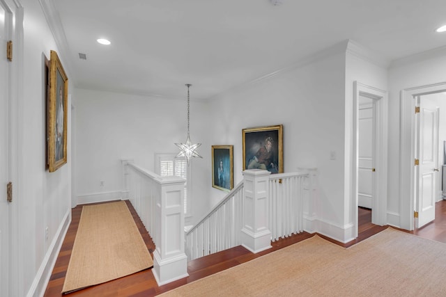 hallway featuring recessed lighting, wood finished floors, an upstairs landing, and crown molding