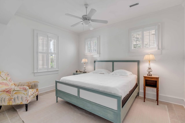 bedroom featuring light tile patterned floors, ornamental molding, ceiling fan, baseboards, and visible vents