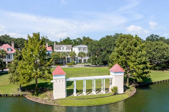 view of property's community with a yard and a water view