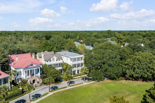birds eye view of property featuring a view of trees