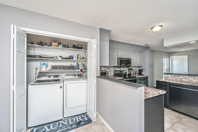 kitchen with electric stove, washing machine and clothes dryer, gray cabinets, stainless steel microwave, and dishwasher