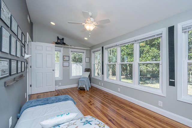 interior space with recessed lighting, wood finished floors, a ceiling fan, baseboards, and vaulted ceiling