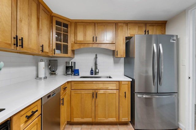 14 Lockwood Dr Unit 1C, Charleston, SC 29401 - kitchen featuring appliances with stainless steel finishes, brown cabinetry, tasteful backsplash, and a sink