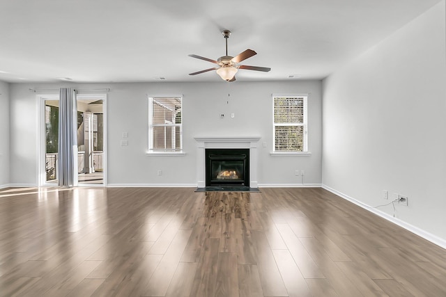 unfurnished living room featuring hardwood / wood-style floors and ceiling fan