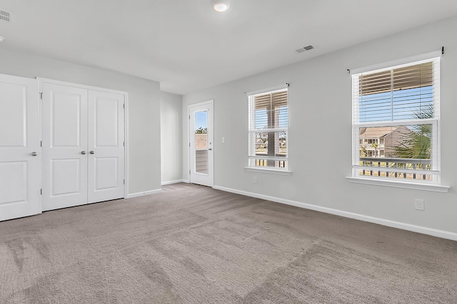 unfurnished bedroom with a closet and carpet floors