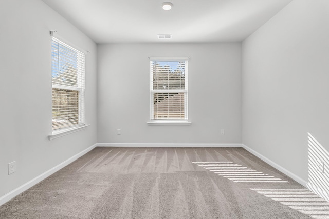 unfurnished room featuring light colored carpet