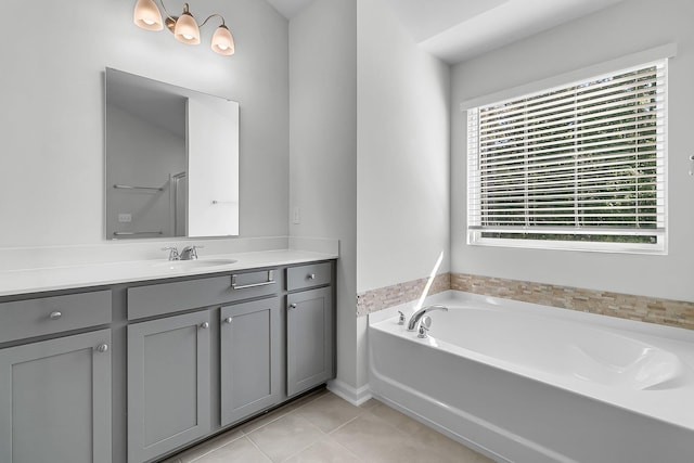 bathroom with vanity, a tub to relax in, and tile patterned floors