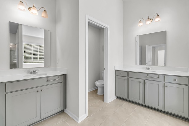 bathroom with vanity, toilet, and tile patterned floors