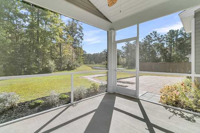 unfurnished sunroom with wooden ceiling, vaulted ceiling, and ceiling fan