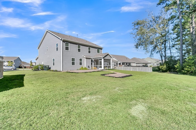 back of house with a lawn