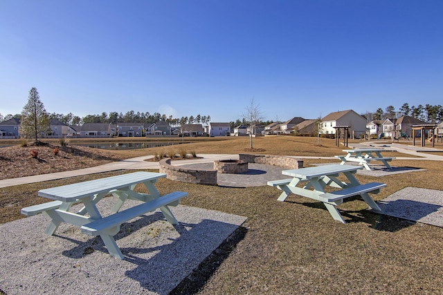 view of community with an outdoor fire pit and a patio area