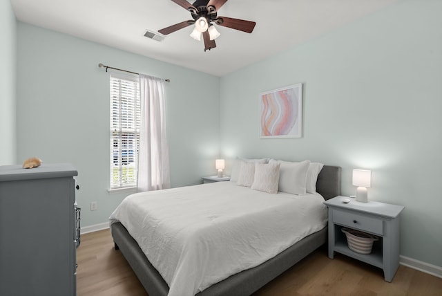 1179 Holly Bend Dr, Mount Pleasant, SC 29466 - bedroom with multiple windows, light wood finished floors, and baseboards