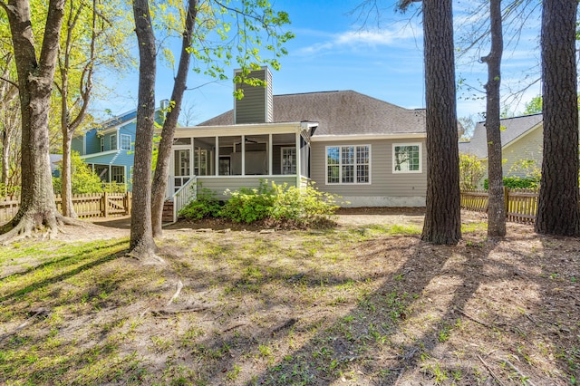 1179 Holly Bend Dr, Mount Pleasant, SC 29466 - rear view of property featuring a sunroom, a chimney, and a shingled roof