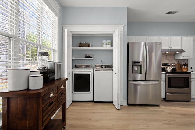 1179 Holly Bend Dr, Mount Pleasant, SC 29466 - kitchen featuring appliances with stainless steel finishes, separate washer and dryer, under cabinet range hood, and healthy amount of natural light