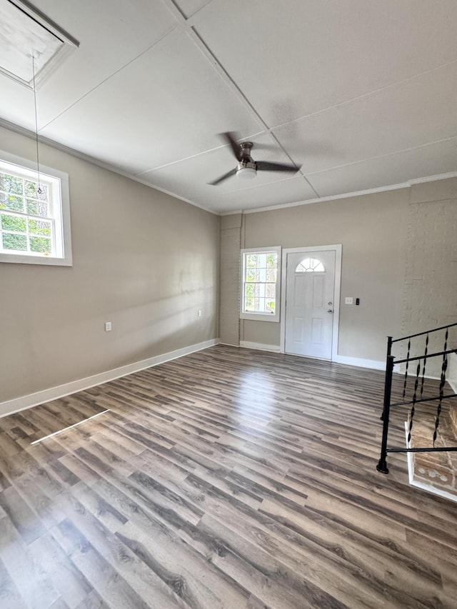 interior space with hardwood / wood-style flooring, ornamental molding, and ceiling fan