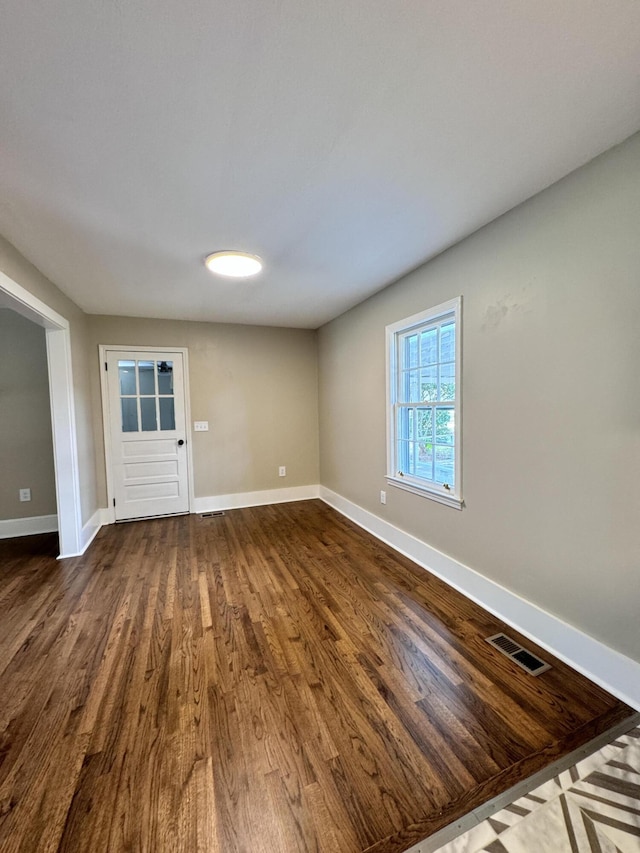 unfurnished room with wood-type flooring