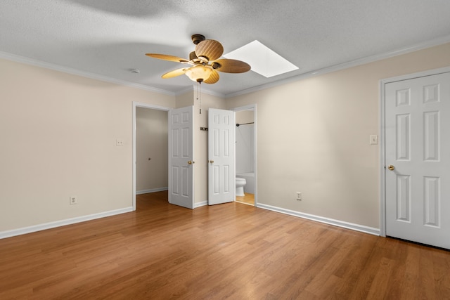 4162 Murrells Inlet Rd, Murrells Inlet, SC 29576 - unfurnished bedroom featuring a skylight, light wood finished floors, ornamental molding, baseboards, and ensuite bath