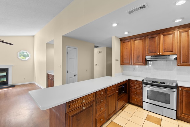 4162 Murrells Inlet Rd, Murrells Inlet, SC 29576 - kitchen featuring stainless steel electric range oven, under cabinet range hood, light countertops, a peninsula, and decorative backsplash