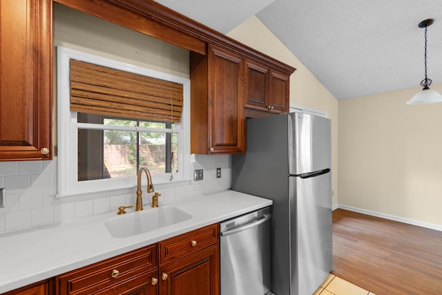4162 Murrells Inlet Rd, Murrells Inlet, SC 29576 - kitchen featuring stainless steel appliances, a sink, vaulted ceiling, decorative backsplash, and decorative light fixtures