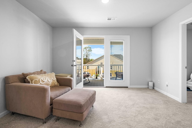 living area with carpet, visible vents, and baseboards