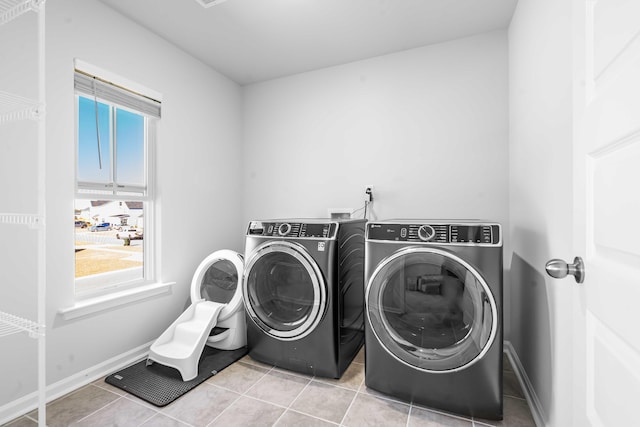 laundry area featuring tile patterned flooring, laundry area, independent washer and dryer, and baseboards