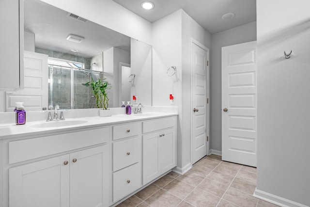 full bath featuring tile patterned floors, visible vents, a sink, a shower stall, and double vanity