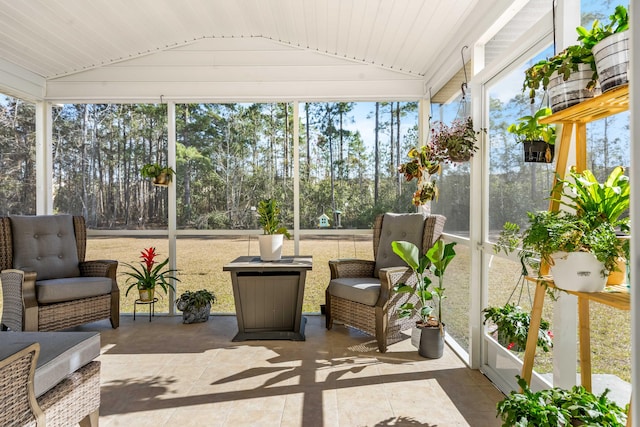 sunroom featuring a wealth of natural light and vaulted ceiling