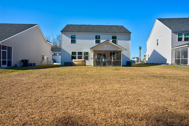 back of house with a yard and a sunroom