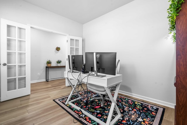 home office featuring wood finished floors, baseboards, and french doors