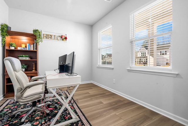 home office featuring baseboards and light wood-style flooring