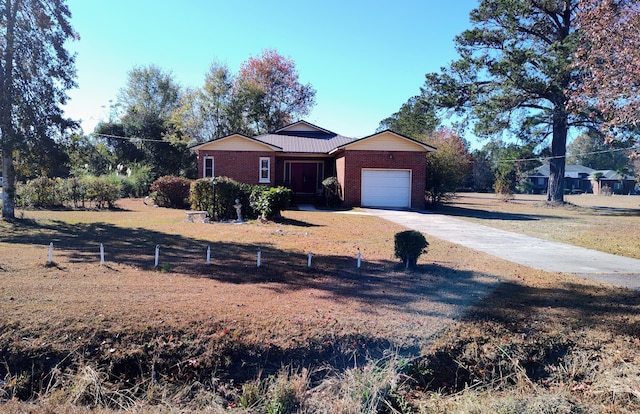 single story home with a front yard and a garage