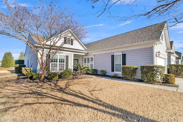 view of front of home with a garage and a front lawn