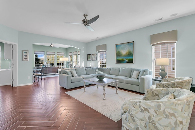 living room featuring dark parquet floors and ceiling fan