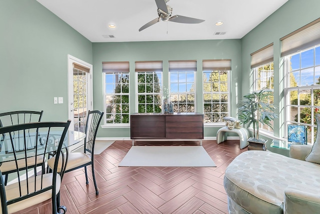 sunroom with a wealth of natural light and ceiling fan