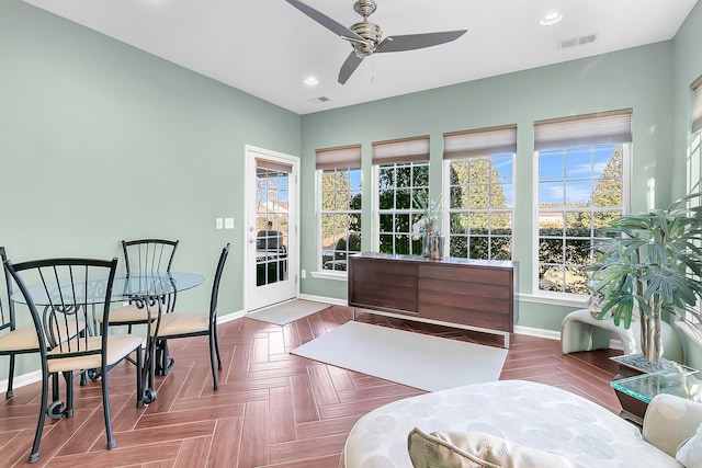 sunroom / solarium featuring ceiling fan