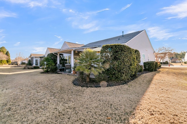 view of home's exterior featuring a yard and a porch