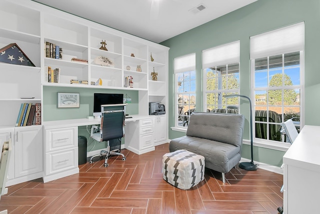 office space with parquet floors and built in desk