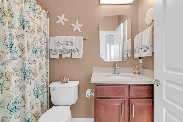 bathroom featuring walk in shower, vanity, and toilet