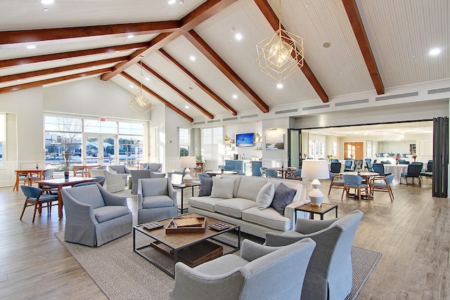 living room with beam ceiling, high vaulted ceiling, and light wood-type flooring