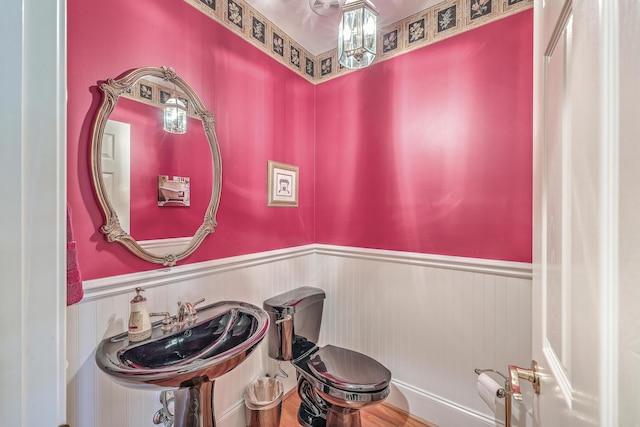 bathroom with toilet, sink, and hardwood / wood-style flooring