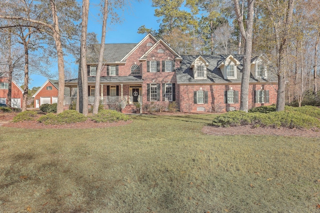 view of front of home with a porch and a front yard